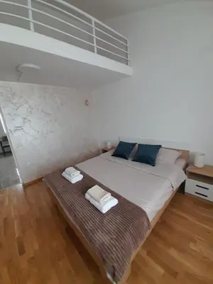 a bedroom with a bed with two towels on it at Nemanjina Centar in Pančevo