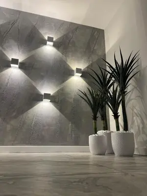 two lights in a room with two potted plants at Agate Apartment in Belgrade