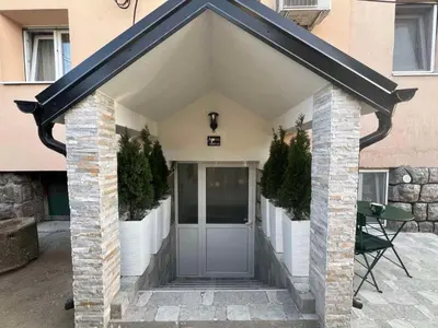 a entrance to a building with a gray door at Agate Apartment in Belgrade