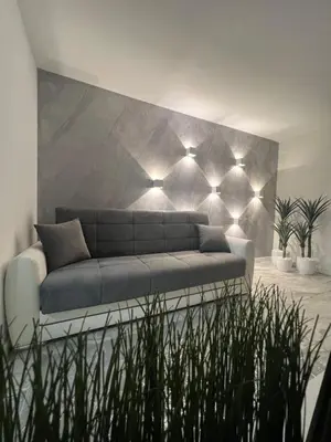 a living room with a couch with lights on it at Agate Apartment in Belgrade