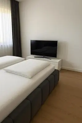 a bedroom with a bed and a flat screen tv at Best View Belgrade Waterfront in Belgrade
