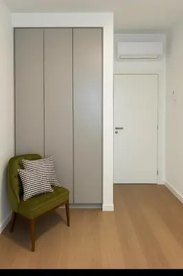 a room with a green chair and a door at Best View Belgrade Waterfront in Belgrade
