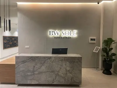 a lobby with a buy sell sign on a wall at Best View Belgrade Waterfront in Belgrade