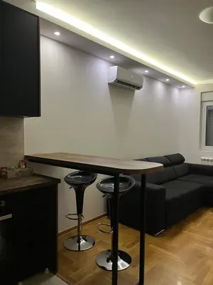 a living room with a table and a couch at Residence 25V in Batajnica