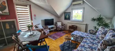 a living room with a couch and a table at Dina cozy apartment in Zemun