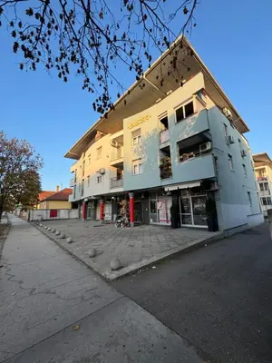 a large building on a street next to a sidewalk at Studio29 in Ruma