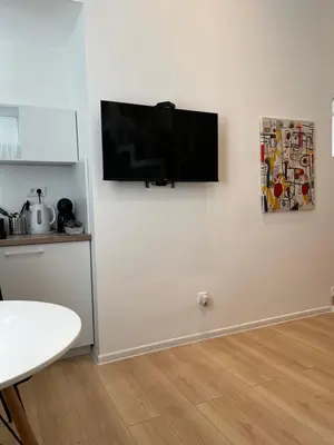 a flat screen tv hanging on a white wall at Mina Luxury Suite 1 in Belgrade