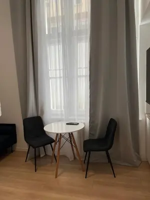 a table and two chairs in front of a window at Mina Luxury Suite 1 in Belgrade