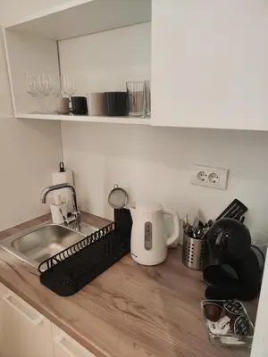 a kitchen counter with a mixer and a sink at Mina Luxury Suite 1 in Belgrade