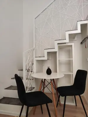 a room with two chairs and a table and stairs at Mina Luxury Suite 2 in Belgrade