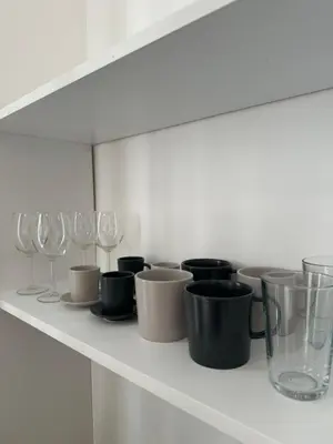 a shelf with glasses and wine glasses on it at Mina Luxury Suite 2 in Belgrade