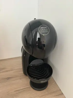 a black coffee maker sitting on a wooden floor at Mina Luxury Suite 2 in Belgrade