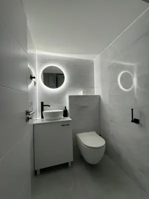 a white bathroom with a toilet and a sink at Mina Luxury Suite 2 in Belgrade