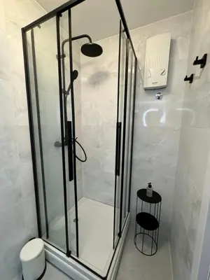 a shower with a glass door in a bathroom at Mina Luxury Suite 2 in Belgrade