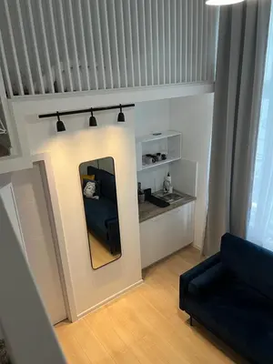 a living room with a mirror and a couch at Mina Luxury Suite 2 in Belgrade