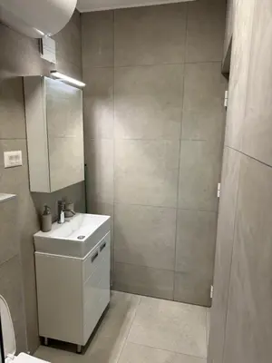 a bathroom with a white sink and a mirror at Sixty three in Novi Beograd
