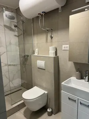 a bathroom with a shower and a toilet and a sink at Sixty three in Novi Beograd