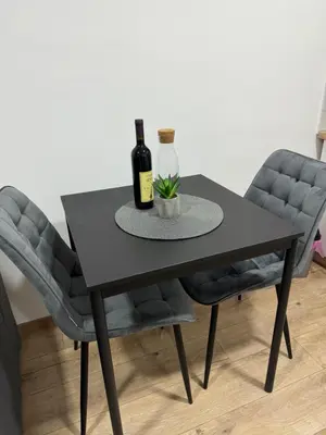 a black dining room table with two bottles of wine at Sixty three in Novi Beograd