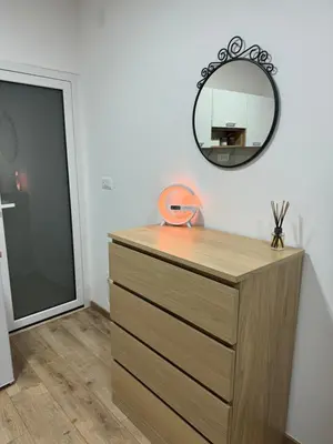 a dresser with a mirror next to a door at Sixty three in Novi Beograd