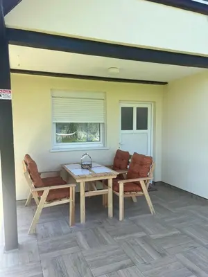 a patio with a table and chairs and a window at Vikendica Živković in Lazarevac