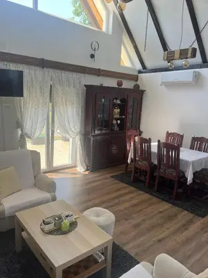 a living room with a table and a dining room at Vikendica Živković in Lazarevac