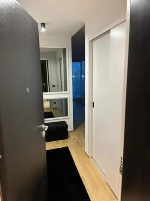 a hallway with a door and a mirror at LL65 Apartments Novi Dorcol in Belgrade