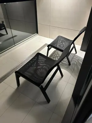 a black chair sitting on a floor in a room at LL65 Apartments Novi Dorcol in Belgrade