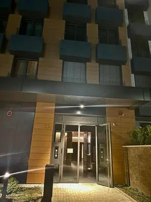 a building with a revolving door in front of it at LL65 Apartments Novi Dorcol in Belgrade