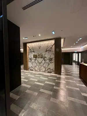 a lobby with a marble wall in a building at LL65 Apartments Novi Dorcol in Belgrade