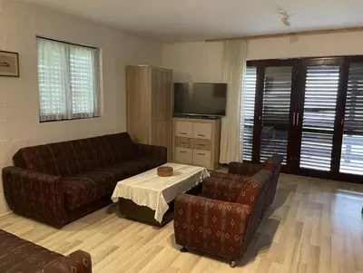 a living room with two leather couches and a television at Vila Plavinac in Smederevo