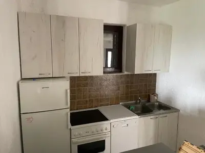 a kitchen with a white refrigerator and a sink at Vila Plavinac in Smederevo