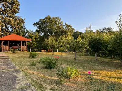 a gazebo in a park with trees and flowers at Vila Plavinac in Smederevo