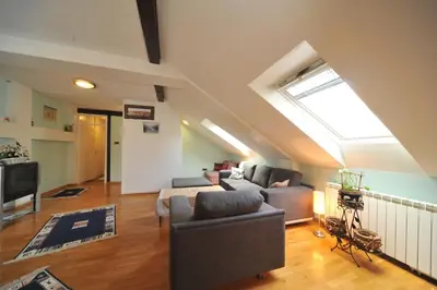 a living room with a couch and a skylight at Apartment Resavska in Belgrade