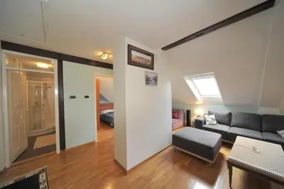 a living room with a couch and a room with a bed at Apartment Resavska in Belgrade