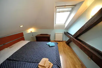 a small bedroom with a bed and a window at Apartment Resavska in Belgrade