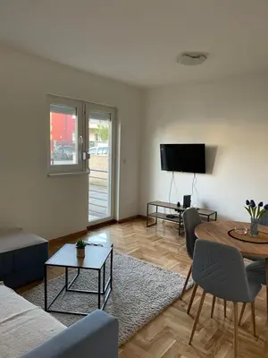 a living room with a couch and a table at Cvetanov trg LUX 4 in Belgrade