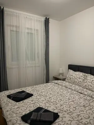 a bedroom with a bed with two towels on it at Cvetanov trg LUX 4 in Belgrade