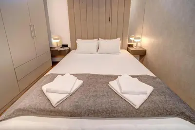 a bedroom with a bed with white towels on it at Apart K Apartments in Belgrade