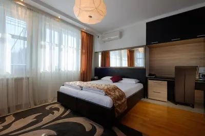 a bedroom with a bed and a large window at Apart K Apartments in Belgrade