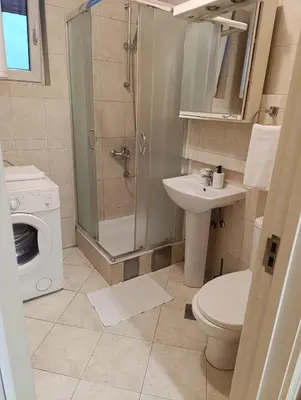 a bathroom with a shower and a toilet and a sink at TWINS in Belgrade