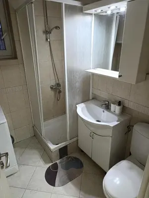a bathroom with a shower and a sink and a toilet at TWINS in Belgrade