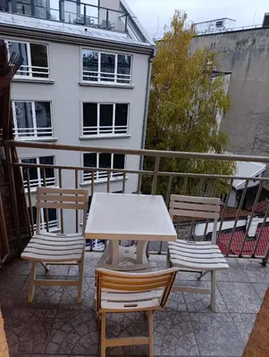 a table and two chairs on a balcony at TWINS in Belgrade