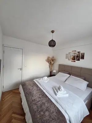 a bedroom with a bed with two towels on it at BMM LUX APARTMENT CENTAR in Belgrade