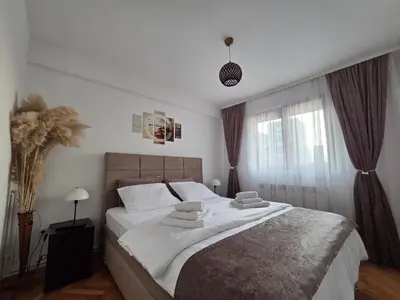 a bedroom with a large bed with towels on it at BMM LUX APARTMENT CENTAR in Belgrade