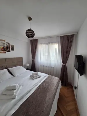 a bedroom with a bed with towels on it at BMM LUX APARTMENT CENTAR in Belgrade