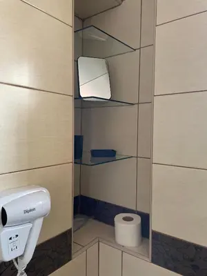 a bathroom with a toilet paper dispenser and a toilet paper holder at BMM LUX APARTMENT CENTAR in Belgrade