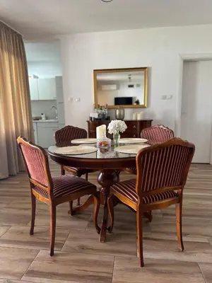 a dining room with a table and two chairs at Beli Dvor na Dunavu in Kovin