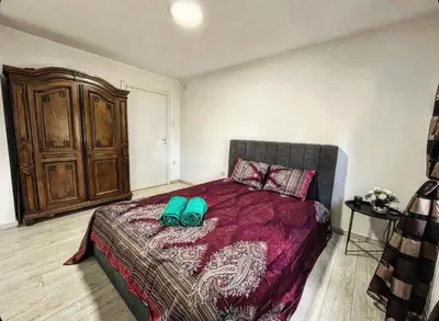 a bedroom with a bed with two green shoes on it at Beli Dvor na Dunavu in Kovin