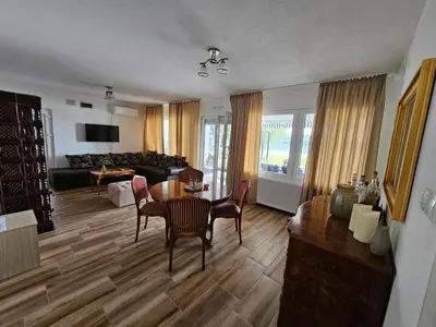 a living room with a table and chairs and a couch at Beli Dvor na Dunavu in Kovin