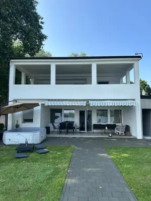 a large white building with a patio in front of it at Beli Dvor na Dunavu in Kovin